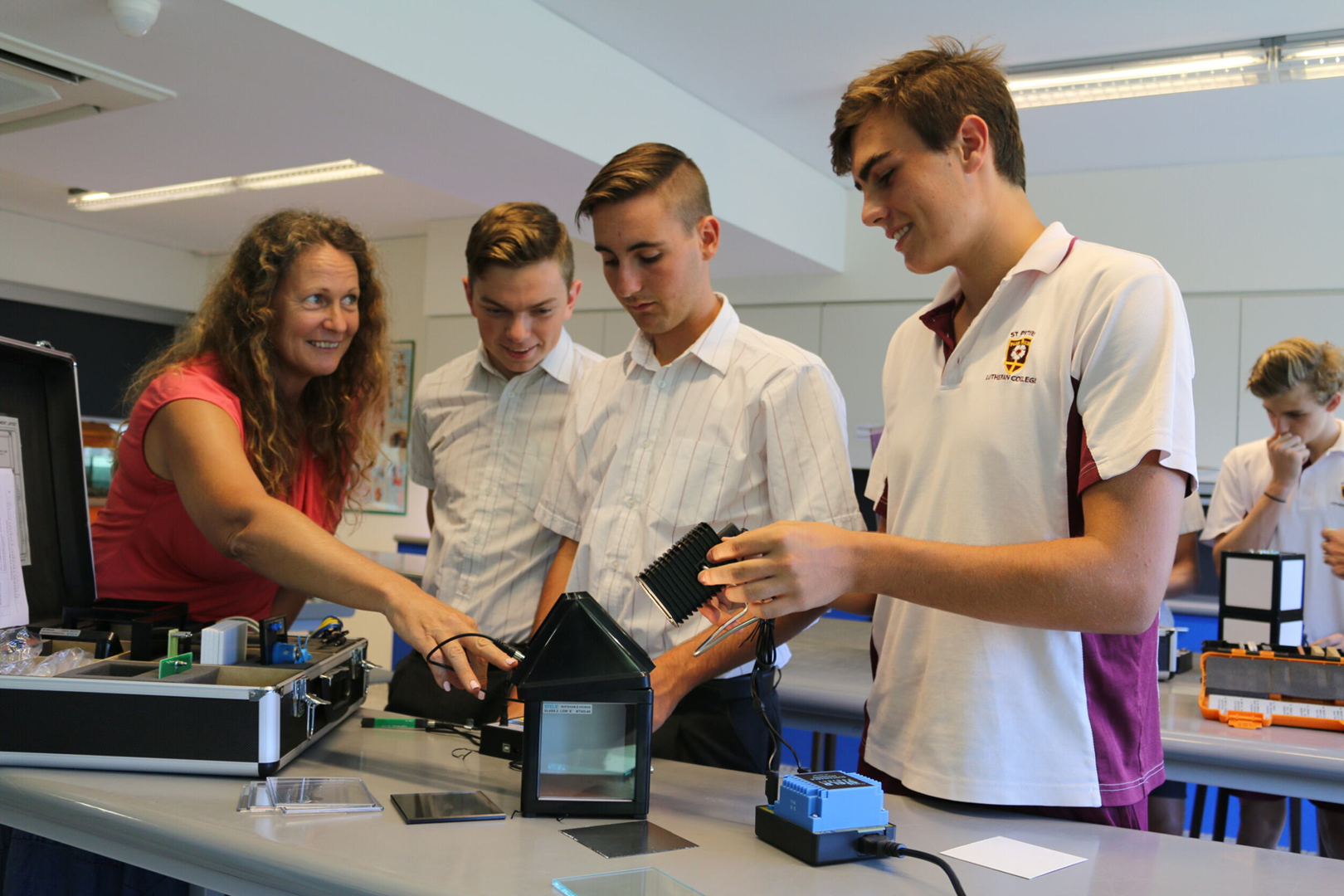 Three Male Students And Teacher with sustainable Housing Kit